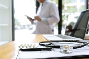 doctor use computer at the window and at tablet to work with the technology or digial health treatment remote work.